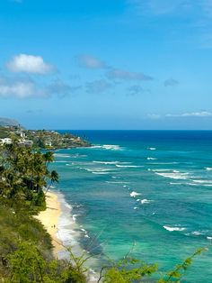 the ocean is blue and green with waves coming in from the shore to the beach