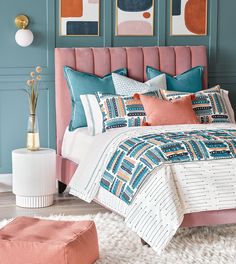 a bedroom with blue walls and pink bedding