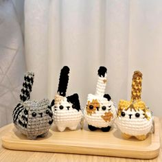 three crocheted animals sitting on top of a wooden table