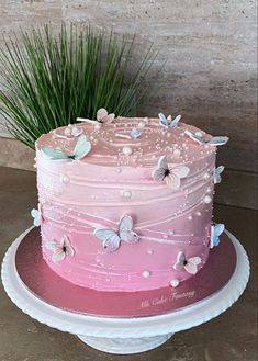 a pink cake sitting on top of a white plate