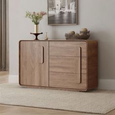 a wooden cabinet sitting on top of a white rug