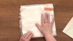 two hands on top of a piece of cloth