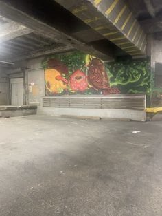 an empty parking garage with graffiti on the wall