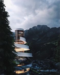 a building that looks like a spiral staircase in the middle of some trees and water