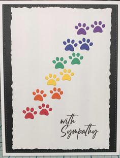 a card with colorful paw prints on it