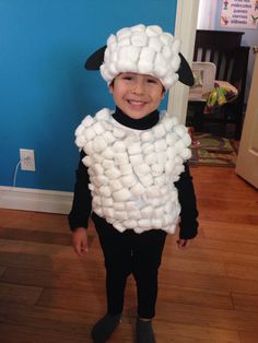 a young boy wearing a sheep costume made out of marshmallows for halloween