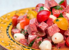 a yellow plate topped with meat and veggies