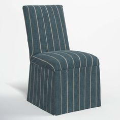 a blue striped chair sitting on top of a white floor