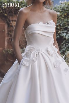 a woman in a white dress with flowers on it