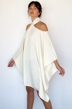 * Please Note: All Sale Items Are Final Sale* Mambo Piccolo Caftan in Ivory from Taller Marmo Caftan style mini dress Cut outs on the shoulders with long billowing sleeves Covered buttons behind neck Draping fluid crepe fabric 78% acetate, 22% viscose One size Made in Italy Model Measurements & Item Sizing: Model Height: 5'8” Model size: US 2 / S / 26 Size shown on model: one size Long Cream Dress, Taller Marmo, Open Shoulder Dress, Drape Dress, Caftan Dress, Dressed To Kill, Draped Dress, Cream Dress, Crepe Fabric