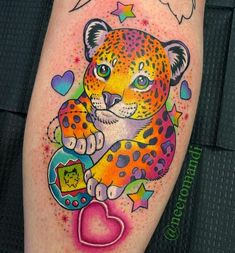 a colorful tattoo on the leg of a woman with a leopard holding a heart in her paws