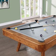 a pool table with several billiards on it and the words west elm above it