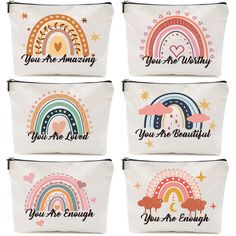 four zippered pouchs with different designs and words on the front, one has a rainbow