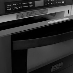 a black and white photo of an oven with the control panel on it's side