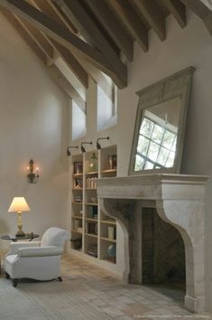 a living room filled with furniture and a fire place in the middle of a room