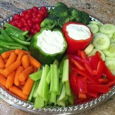 a platter filled with veggies and dip