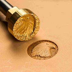 a close up of a metal object with a coin on the table next to it