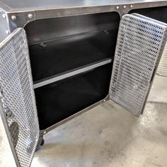 an open metal cabinet sitting on top of a floor