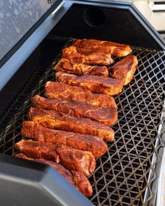 the meat is being cooked on the grill