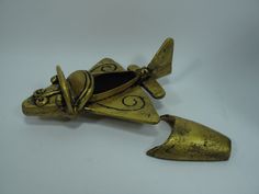 an antique brass figurine shaped like a mouse