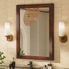 a bathroom vanity with two lights and a mirror