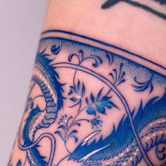 a close up view of a tattoo on someone's arm with an intricate design