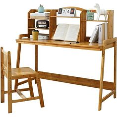 a wooden desk and chair with an open book on the shelf next to each other