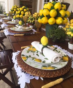 the table is set with lemons and plates