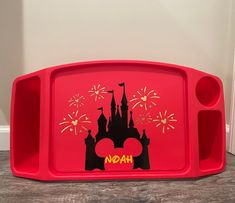 a red tray with the word noah painted on it and fireworks in the sky above