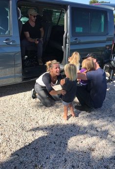 a group of people sitting in the back of a van