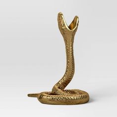 a gold snake statue on a white background