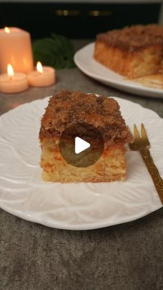 a piece of cake sitting on top of a white plate next to a knife and fork