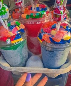 a tray filled with lots of candy and candies on top of ice cream cones