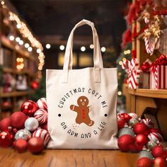 a white bag sitting on top of a wooden table next to christmas ornaments and decorations