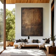 a living room filled with furniture and a large painting hanging on the wall above it