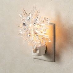 a light that is on the side of a wall with a snowflake design