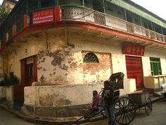 an old building with a horse and buggy parked in front of it on the street