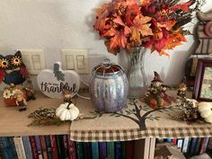 a table topped with lots of fall decorations