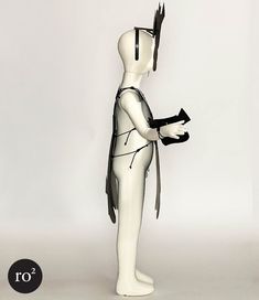 a white mannequin with black hair holding a piece of paper