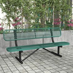 a green park bench sitting on top of a tiled floor next to potted plants