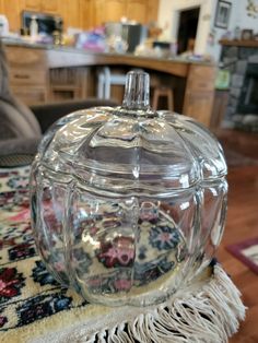 a glass jar sitting on top of a rug