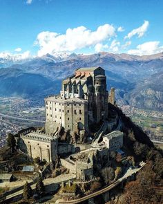 an old castle sits on top of a mountain