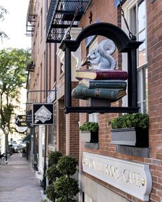 a sign that is on the side of a building with books in front of it