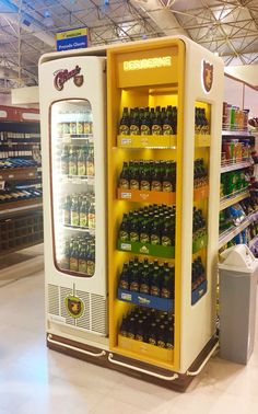 a vending machine in a grocery store filled with drinks