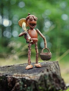 a small figurine holding a basket on top of a tree stump