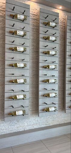 wine bottles are lined up on the wall