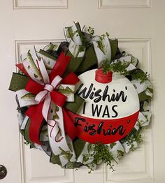 a wreath that says wishin'i was fishin'on the front door