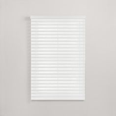 a white window blind with horizontal blinds on the top and bottom, in front of a gray wall