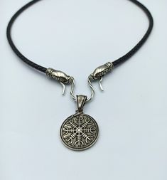 This Norse style pendant is made from Silver solid (without stamp) by hand casting. The pendant is combined the Aegishjalmur (Helm of Awe) - the icelandic magic symbol and Urnes art style ornament. The necklace is made from natural leather cord, default length 24 inch. If you like Viking or Nordic style jewelry this item I made just for you. Pendant height: 1 9/10 inch | 50 mm Pendant width: 1 1/4 inch | 32 mm Weight: 14 gm | 0.5 oz Other items in my shop: https://etsy.me/2YZKfPZ Norse Necklace, Hand Casting, Helm Of Awe, Norse Jewelry, Shield Ring, Magic Symbols, Viking Necklace, Pagan Jewelry, Viking Jewelry