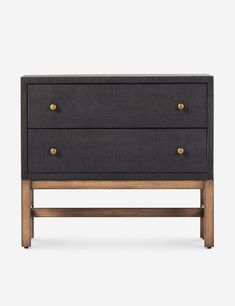 the sideboard with two drawers is shown in black linen and wooden legs, along with brass knobs